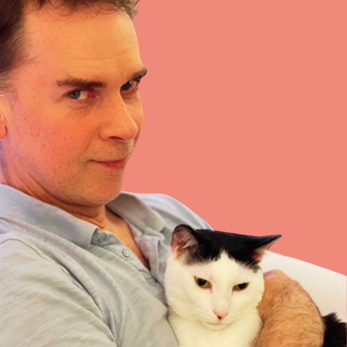 Cory Jones holding one of the cats