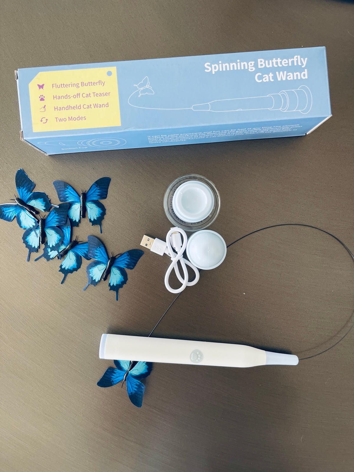 Spinning Butterfly Cat Wand unboxed: wand, suction cup base, USB charging cable, and blue replacement butterflies